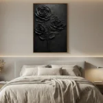 Textured monochrome hand-painted canvas depicting three dimensional black roses with layered petals and stem, contemporary bedroom