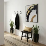 Contemporary abstract hand-painted canvas with gestural black and gold brushstrokes on cream, modern entryway