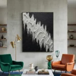 Textured abstract hand-painted canvas in monochromatic black and white with gestural dripping forms, contemporary living space
