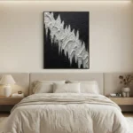 Textured abstract hand-painted canvas in monochromatic black and white with dramatic jagged peaks and layered relief, modern bedroom