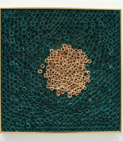 Textured contemporary wall art featuring natural wooden rings clustered on hand-painted teal canvas with gold frame