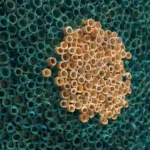 Contemporary textured wall art featuring clustered wooden and turquoise tubes in dimensional relief, handcrafted canvas