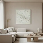 Textured abstract hand-painted canvas with layered cream and gold leaf topography in circular composition, contemporary living space