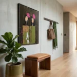 Contemporary hand-painted canvas featuring abstract floral subjects with pink blooms and textured chartreuse vases, dark tonal background, modern entryway