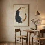Contemporary abstract hand-painted canvas with organic curved forms in navy, gold leaf, and cream, dining space