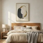 Minimalist abstract hand-painted canvas in charcoal and gold leaf organic forms, contemporary bedroom setting