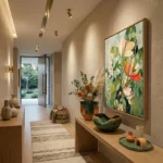 Contemporary figurative hand-painted canvas depicting vibrant wildflowers in coral, green and cream tones, modern entryway