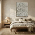 Textured abstract hand-painted canvas with layered grey and silver brushstrokes in flowing organic patterns, modern bedroom setting