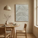 Textured abstract hand-painted canvas with layered cream and silver wave patterns, contemporary dining space