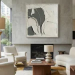 Textured abstract hand-painted canvas in cream and charcoal with layered gestural brushstrokes, contemporary living space