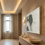 Contemporary abstract hand-painted canvas in textured cream and charcoal, minimalist entryway setting