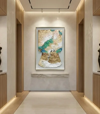 Textured abstract hand-painted canvas depicting layered mountain landscape in cream, gold, and teal tones, gallery hallway setting