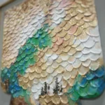 Textured hand-painted canvas featuring iridescent fish scales in emerald, gold, and cream with delicate forest silhouettes