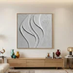 Textured abstract hand-painted canvas with layered white curved forms and sculptural relief details in monochrome, contemporary living space