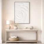 Minimalist hand-painted canvas of a white rose in soft tonal relief, contemporary entryway