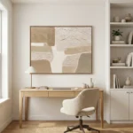Textured abstract hand-painted canvas in cream and sand tones with layered gestural brushstrokes, contemporary workspace