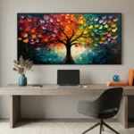 Textured contemporary hand-painted canvas depicting a vibrant tree with multicolored foliage in reds, oranges, yellows, and greens against a moody teal background, modern workspace