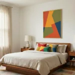 Gestural abstract hand-painted canvas with interlocking geometric shapes in vibrant red, yellow, green, and blue tones, modern bedroom