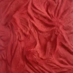 Textured abstract hand-painted canvas in deep crimson and scarlet tones with gestural brushwork, contemporary living space