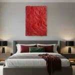 Textured abstract hand-painted canvas in bold crimson with gestural brushwork, modern bedroom setting