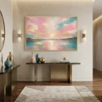 Impressionist landscape hand-painted canvas depicting serene sunset over water in pink, gold, and turquoise tones, contemporary entryway