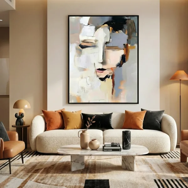 Abstract expressionist hand-painted canvas depicting a stylized face in cream, black, and ochre tones, contemporary living space