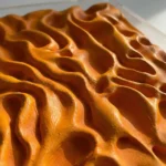 Textured abstract hand-painted canvas in warm ochre and burnt orange with organic flowing forms and dimensional relief details
