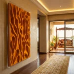 Textured abstract hand-painted canvas in warm amber and burnt orange with organic wavy forms, luxury entryway