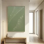 Textured abstract hand-painted canvas in soft sage green with white gestural marks, contemporary entryway