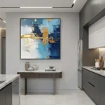Gestural abstract hand-painted canvas with layered blue, gold, and cream brushstrokes, displayed in contemporary kitchen