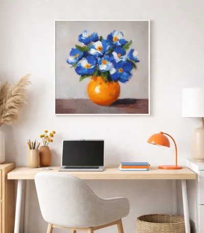 Contemporary hand-painted canvas of blue and white flowers in vibrant orange vase, warm neutral palette, modern workspace
