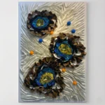 Textured contemporary wall art featuring three dimensional flower forms with golden gemstone centers, layered in browns, blues and creams with scattered colored spheres