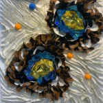 Contemporary textured hand-painted canvas featuring layered dimensional flowers with iridescent blue and golden yellow petals, bronze and cream tones, accented with scattered orange spheres