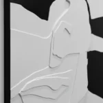 Minimalist hand-painted canvas depicting abstract facial contours in soft grey and white tones, contemporary space