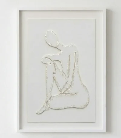 Minimalist hand-painted canvas depicting a seated female figure in textured white relief, contemporary living space