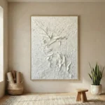 Textured abstract hand-painted canvas depicting gestural figure in monochromatic white and cream tones, contemporary interior