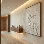Textured figurative hand-painted canvas depicting an ethereal winged figure in cream and ivory relief, contemporary entryway