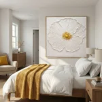Textured contemporary hand-painted canvas of white peony with golden center in cream and gold palette, modern bedroom setting
