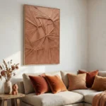 Textured abstract hand-painted canvas in layered terracotta and rust tones with radiating geometric forms, contemporary living space
