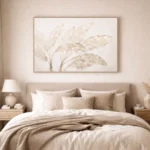 Minimalist hand-painted canvas depicting delicate botanical leaves in soft beige and cream tones, contemporary bedroom