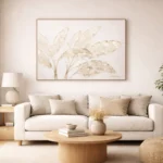 Minimalist hand-painted canvas depicting delicate botanical leaves in muted cream and taupe tones, contemporary living space