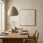Minimalist hand-painted canvas featuring repetitive moon phase motifs in cream and soft grey tones, contemporary dining space