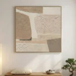 Textured abstract hand-painted canvas in layered cream and sand tones with dimensional brushwork, contemporary living space
