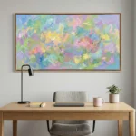 Gestural abstract expressionist hand-painted canvas in vibrant pastel brushstrokes, layered with yellow, pink, blue and green, contemporary workspace
