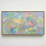 Gestural abstract hand-painted canvas in soft pastels with layered brushstrokes of yellow, pink, blue and green, contemporary living space