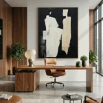 Minimalist abstract hand-painted canvas in cream and black with gestural forms, modern office space