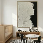 Textured monochrome hand-painted canvas with profile silhouettes in layered cream and charcoal, modern nursery