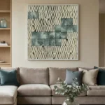 Textured abstract hand-painted canvas with geometric woven pattern in cream and slate green tones, contemporary living space