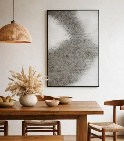 Textured abstract hand-painted canvas with dispersing particle motif in charcoal and cream tones, contemporary dining space