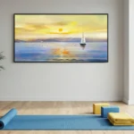 Impressionist seascape hand-painted canvas depicting golden sunset with sailing boat and distant mountains in warm yellows and cool blues, yoga studio setting